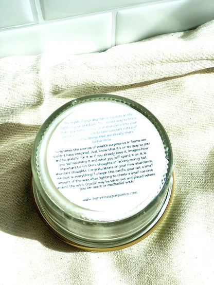 Bottom view of the Abundance Ritual Candle, showcasing its label and natural soy wax design.